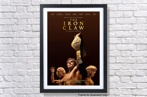 the iron claw movie poster hanging on a brick wall